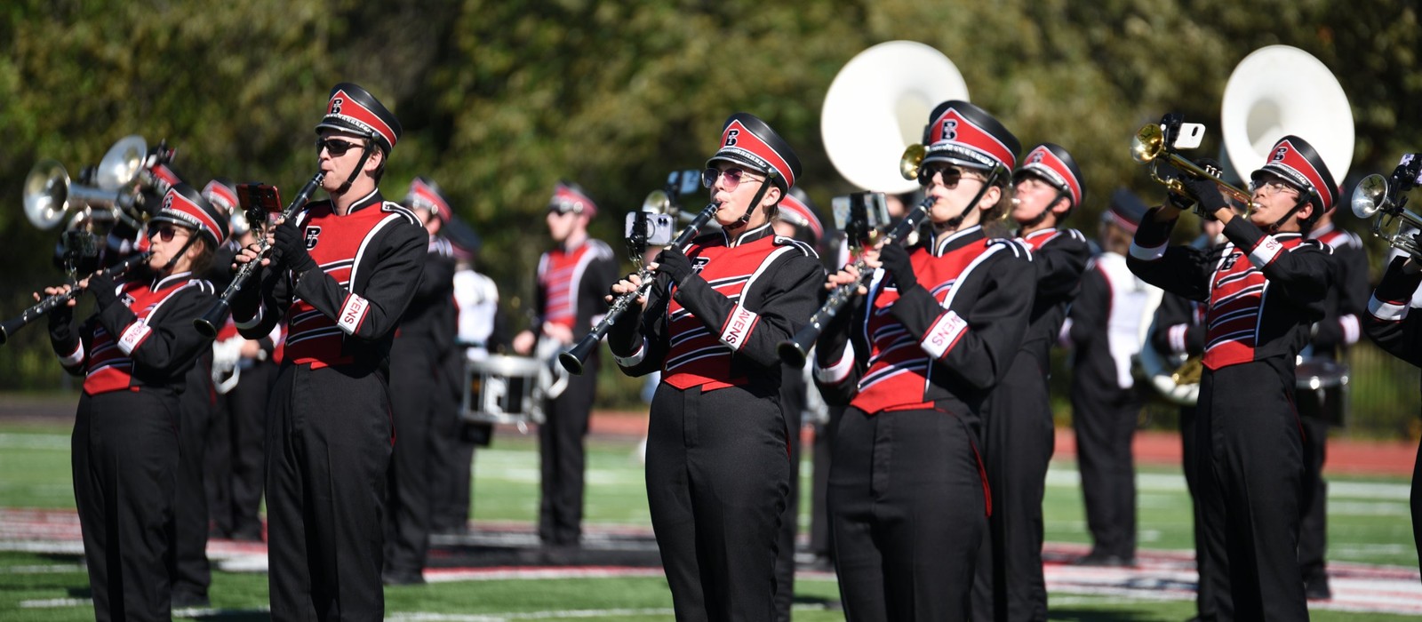 Raven Regiment members performing on the field in Benedictine College uniforms